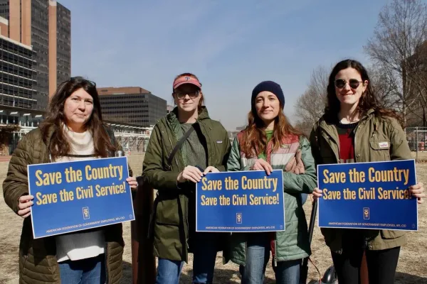 Civil workers holding signs